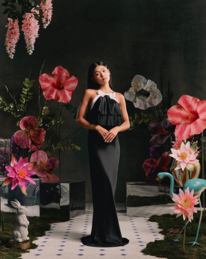 black dress lady model with flower backdrop