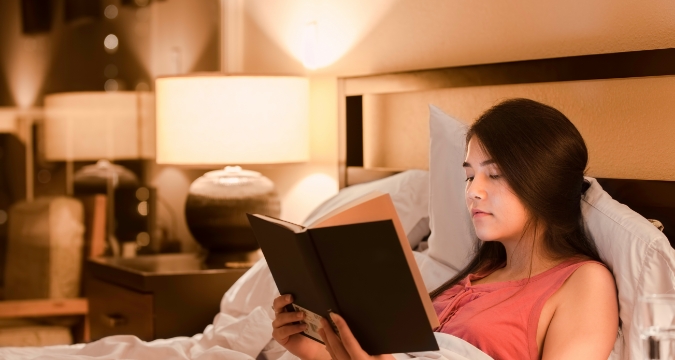 Picture of woman reading book before bed