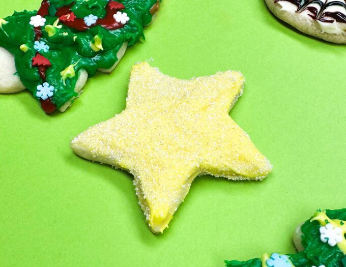image of sanding sugar dipped star shape cookie with green backgound