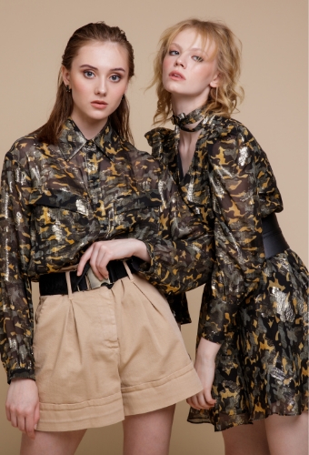 Two Models Posing In Brownish Clothing