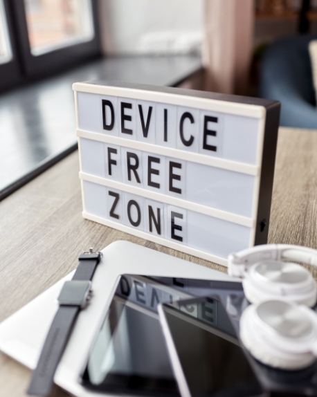 Small sign that says Device Free Zone on office desk