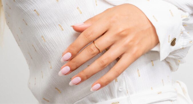 Model showing white painted nails on her hands